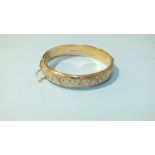 A silver-gilt hinged bangle, (6cm x 5.5cm inside), 20g.