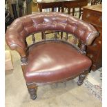 An Edwardian walnut button-back tub armchair, with upholstered rail, on turned spindles, the
