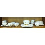 A Carlton China 'Sylvan' decorated tea part-service comprising six cups and saucers, five sandwich