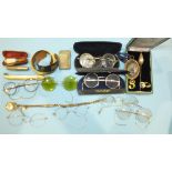 A collection of vintage spectacles, a yellow metal watch chain and compass fob and other items.