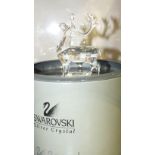 A Swarovski crystal glass figure of a reindeer, boxed.