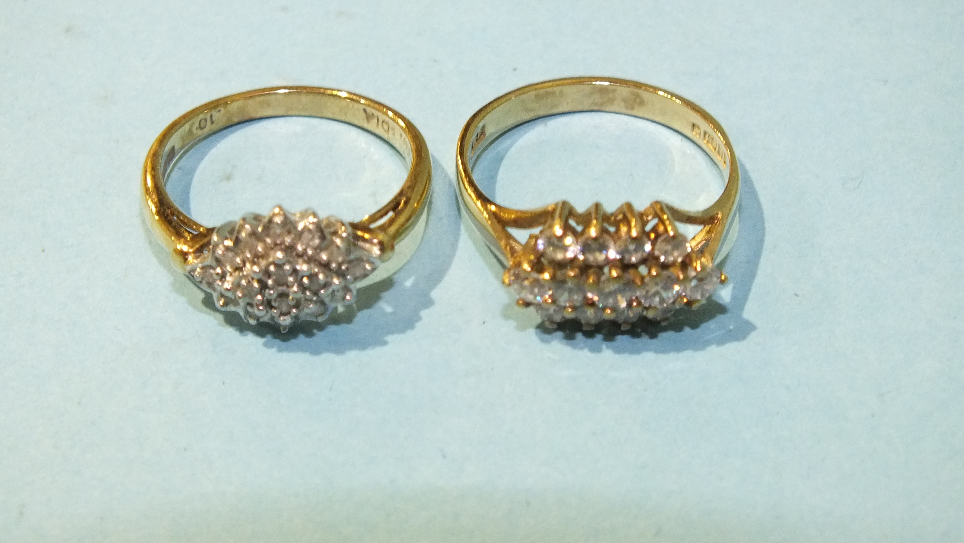 A 9ct gold ring set diamond cluster, size K, 2.5g and another 9ct gold ring set three rows of