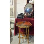 A mahogany oval swing dressing table mirror, a small cast iron fender, 59cm long, a bamboo