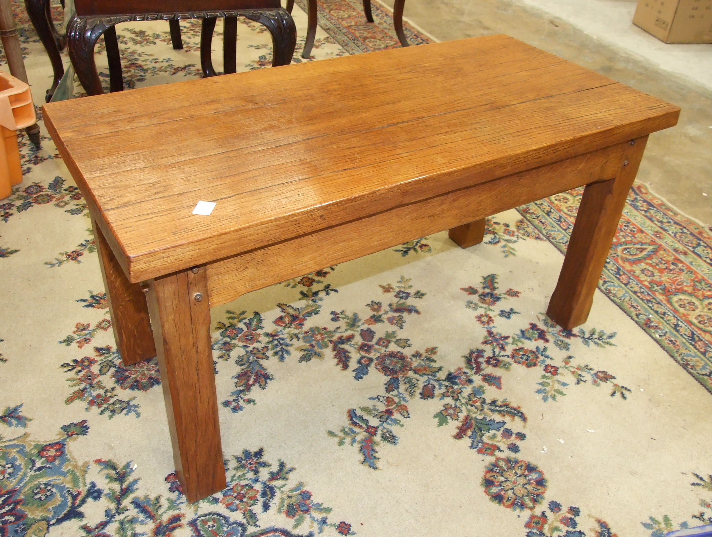 A modern craftsman-built hardwood rectangular coffee table on short chamfered legs, 42cm wide,