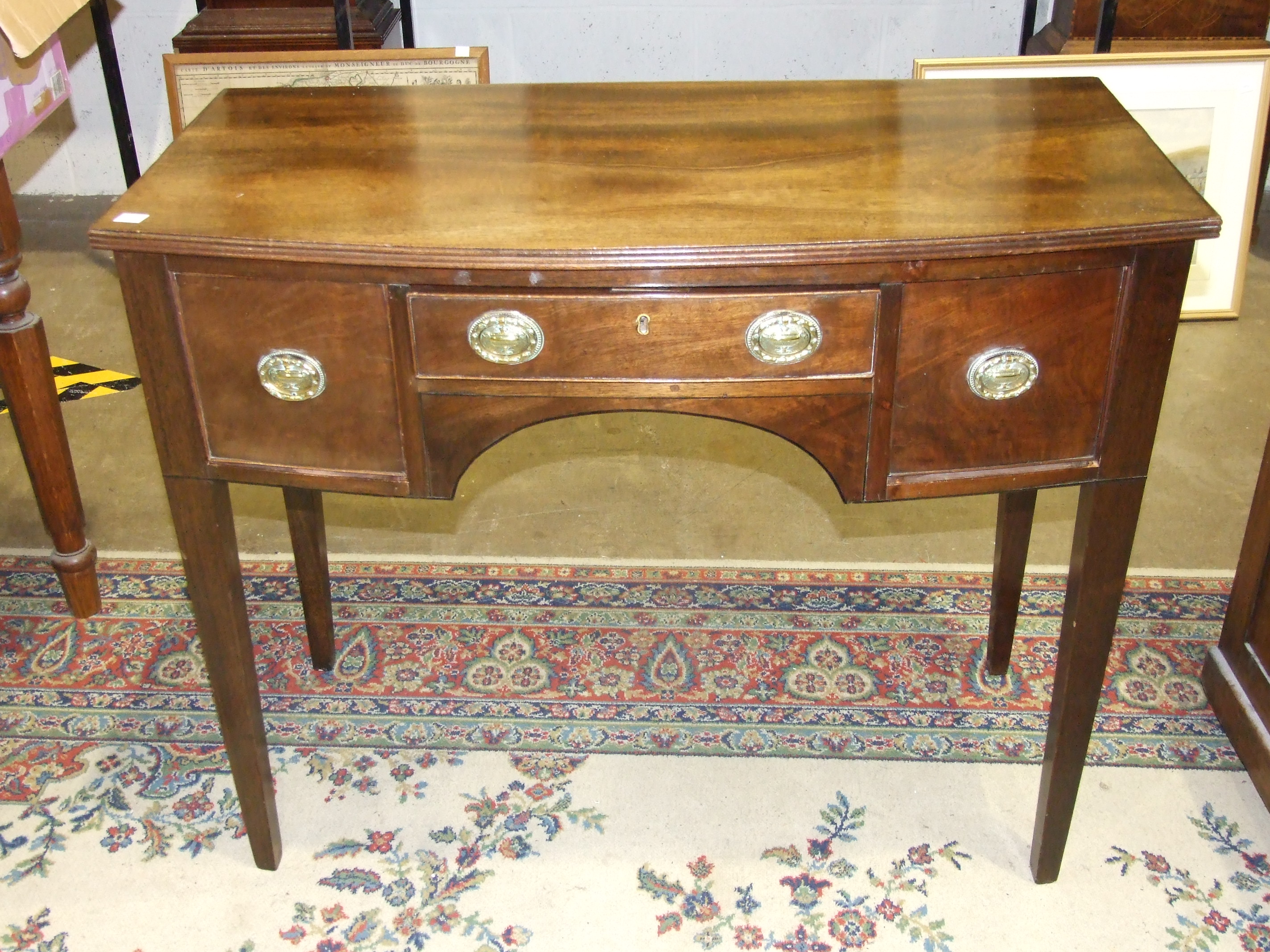 A Georgian-style mahogany small bow-fronted knee-hole dressing table, on tapered legs, 99cm wide,