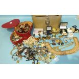 A quantity of costume jewellery in a heart-shaped jewellery case and a vanity case.