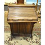 A small oak roll-top 'The Lebus' desk with fitted interior and side drawers, 72cm wide, 106cm high.