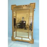 A Victorian gilt gesso rectangular pier mirror, the central plate enclosed by ten smaller plates, 74