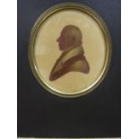 A 19th century sepia painted silhouette portrait, signed Foster pinx, dated 1894, within an oval