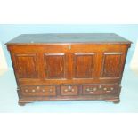 A George III mahogany-banded oak panel mule chest, the lift lid above a panel and three drawers,