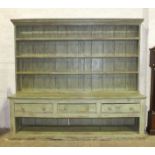 A very large 19th century pine dresser with moulded cornice above four shelves, the lower part