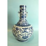 A Chinese bottle shaped vase with blue and white foliate decoration and pierced handles, seal mark