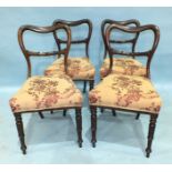 A set of four Victorian rosewood balloon-back dining chairs, each with carved centre bar and