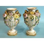 A pair of mid-19th century English porcelain floral-encrusted urn-shaped vases with ram's head