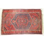 A mid-20th century Oriental rug, the central medallion and serrated border surrounded by birds and