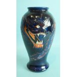 A modern Moorcroft ovular-shaped vase decorated with a dragon on blue ground, 25.5cm high, factory