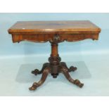 A Victorian rosewood fold-over card table on turned carved column and cabriole quadruped supports,