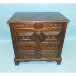 A 17th century oak chest of four harlequin drawers applied with mouldings, on later bracket feet,