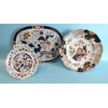 An early-19th century ironstone china drainer in Imari colours, 35cm and two ironstone plates, (3).