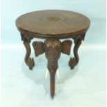 An early-20th century Indian carved hardwood circular centre table, the top carved with concentric