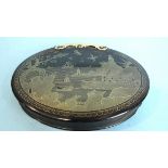An 18th century tortoiseshell and gold piqué snuff box the oval lid inlaid with a town and