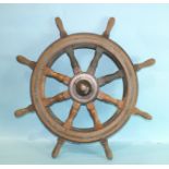 A Simpson Lawrence teak eight-spoke ship's wheel, with brass bindings and boss with maker's name.