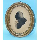 N Phelps (attrib.) A late-18th century painted silhouette portrait of a gentleman in black and