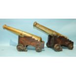 An unusual pair of bronze signalling canons, each 55cm barrel with Victorian cipher, supported by