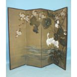 An early-20th century Japanese four-fold screen painted with a pair of cranes surrounded by