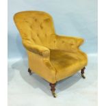 A Victorian upholstered button-back salon armchair, on short turned mahogany legs with Copes