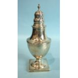 A George III pepper caster of baluster form, with pierced finialled cover and reeded borders, on