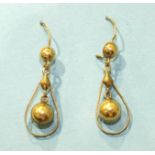 A pair of 14k gold pendant earrings, each with suspended ball, within teardrop-shaped frame, 42mm
