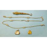 A small button hook with 9ct-gold-cased handle, a small gold nugget, 1.5g and other items.