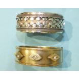 A Victorian silver hinged bangle set three white paste stones, Birmingham 1882, 32g and another, (