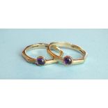 A pair of 9ct gold rings, each collet-set an amethyst cabochon, size O, 4.7g.