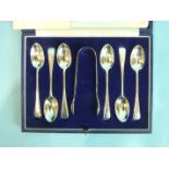 A set of six feather-edge teaspoons and matching sugar tongs, in case, by Goldsmiths, Silversmiths