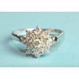 A diamond cluster ring claw-set seventeen brilliant-cut diamonds, in 18ct white gold mount, size