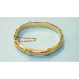 A 15ct gold hinged bangle of bamboo design, inner measurement 56 x 49mm, 14.3g.