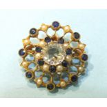 An Edwardian sapphire and pearl circular brooch/pendant, centrally-set a white sapphire within