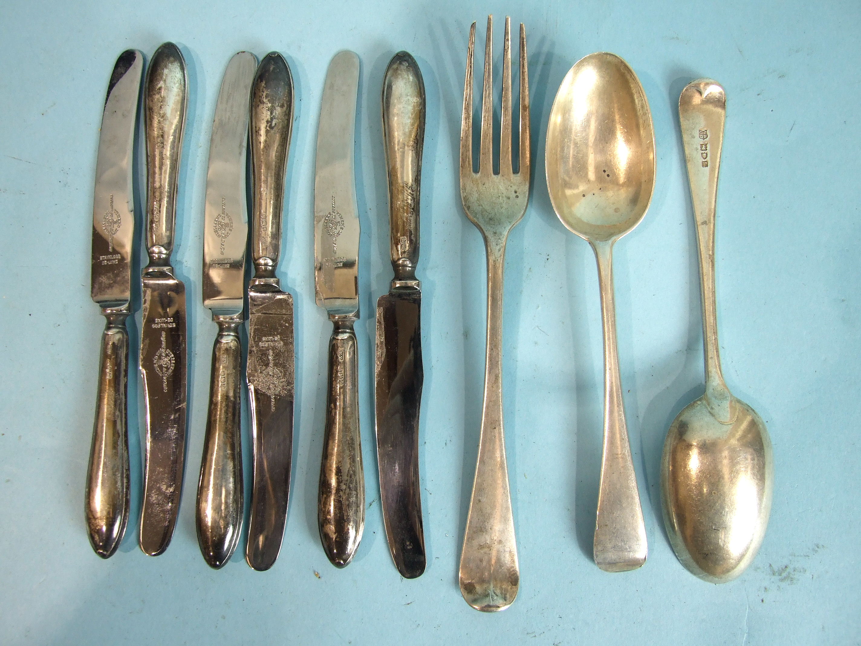 A Georgian Old English pattern table fork, London 1808, a pair of dessert spoons, London 1912 and