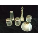 A collection of silver-mounted cut-glass dressing table bottles and a silver-mounted glass match
