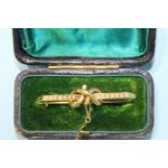 A Victorian pearl-set brooch of bar and knot design, 43mm long, 3g, cased.