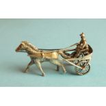 A silver miniature model of a jockey harness racing, 51mm long, marked Silver 900.