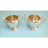 A modern white metal cream jug and bowl, of plain baluster form on circular feet, stamped Sterling