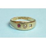 An 18ct gold gypsy ring set a diamond and one ruby, (other setting vacant), size L, 2.6g.