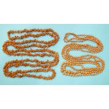 A necklace of two strings of graduated coral beads and a long coral twig necklace, (2).