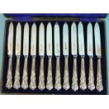 A set of twelve embossed silver-handled fruit knives, in fitted case.