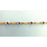 An 18ct gold bracelet of eight white gold links, each set a square-cut sapphire between two