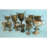 A collection of twelve two-handled trophy cups, various sizes, dates and makers, total weight