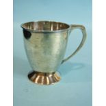 A plain christening mug on spreading foot, with angular handle, 8.5cm high, Birmingham 1932, maker